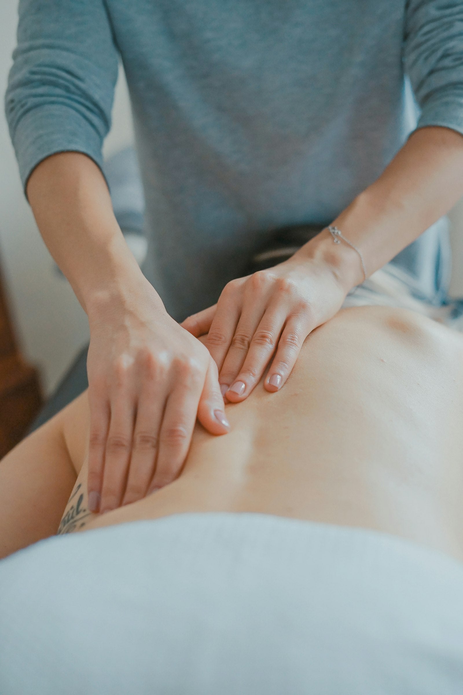 Physical therapist applying electrical muscle stimulation therapy